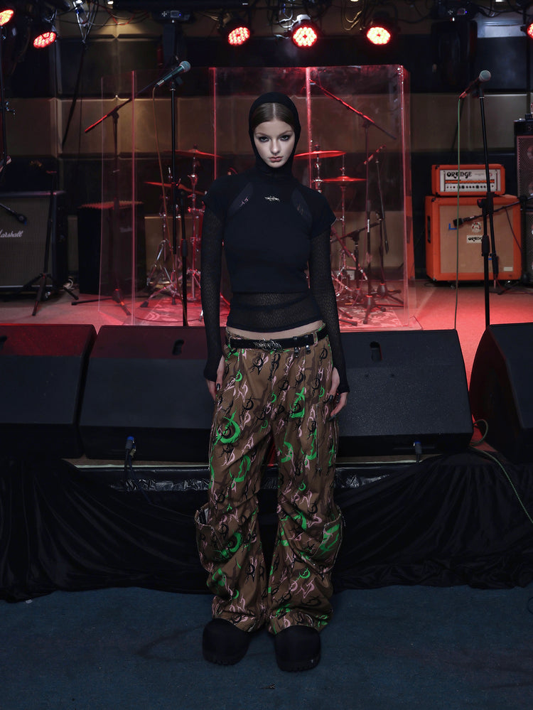 PINKSPINK ELECTRIC MOON sculpted camo cargo trousers in CAMOUFLAGE — full front with black layered top.