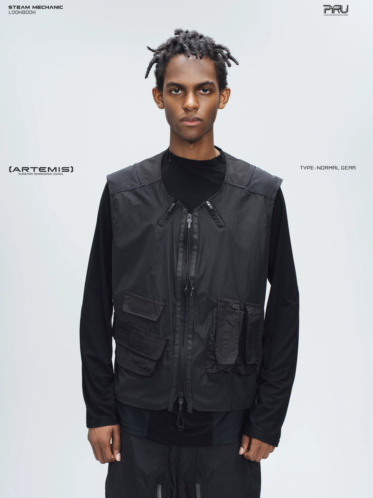 CLERIC utility nylon vest in stardust black — front modeled close-up showing the split neckline, drawcord and asymmetric pockets