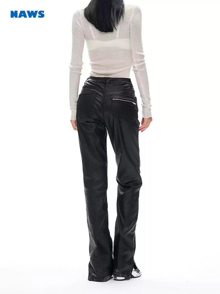 NAWS wax-coated zip-hem jeans in BATIK BLACK — modeled rear view showing the zipped back pocket and coated finish.