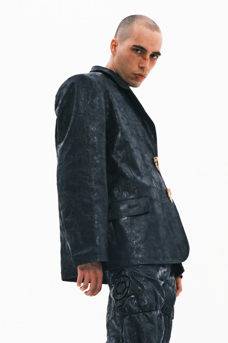 EMBRYO HORN CODE textured PU leather blazer — rear modeled view