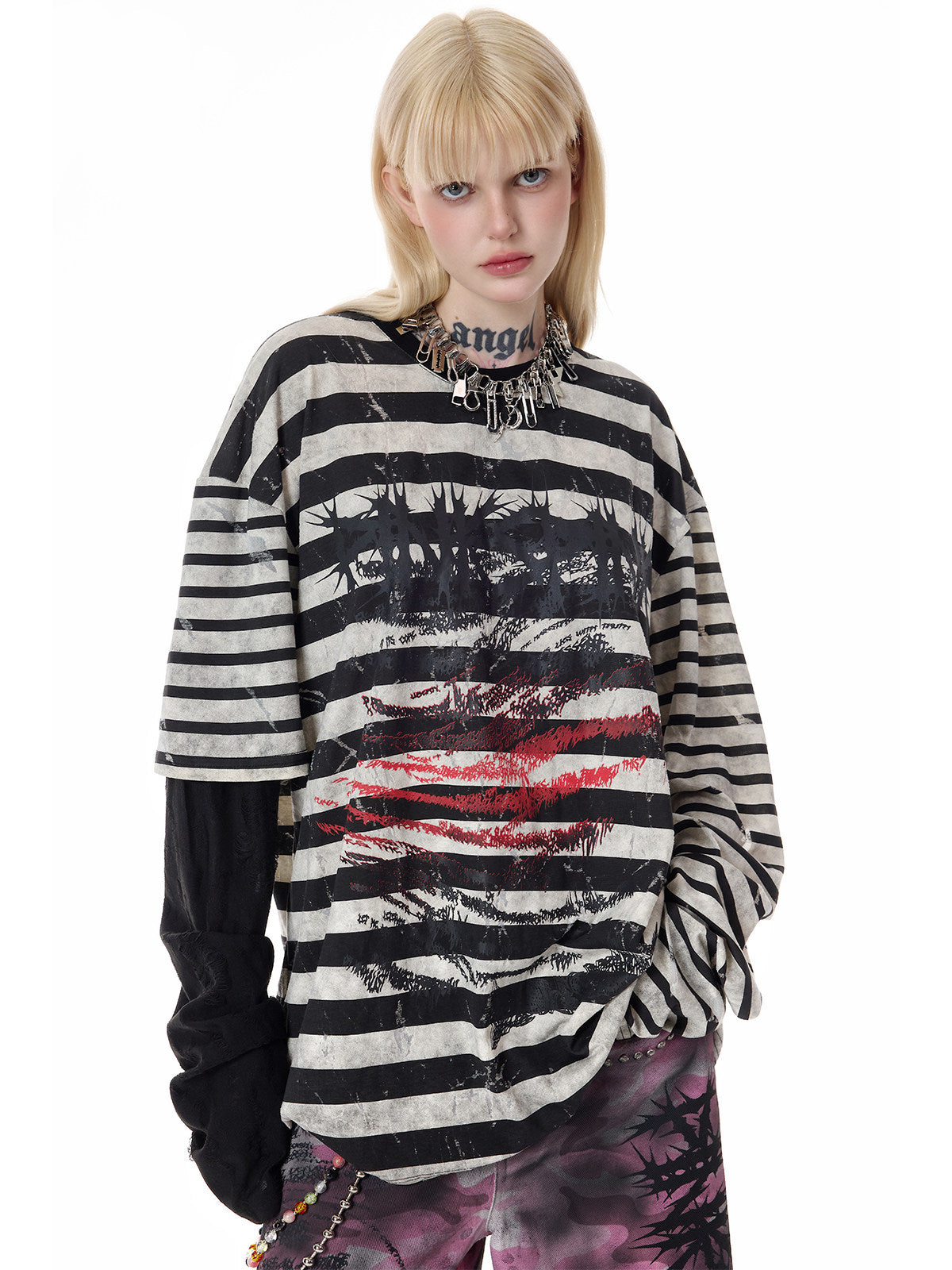 PINKSPINK STATIC asymmetric striped burnout long-sleeve tee in black and white — close front modeled view showing the distorted face and red lip graphic