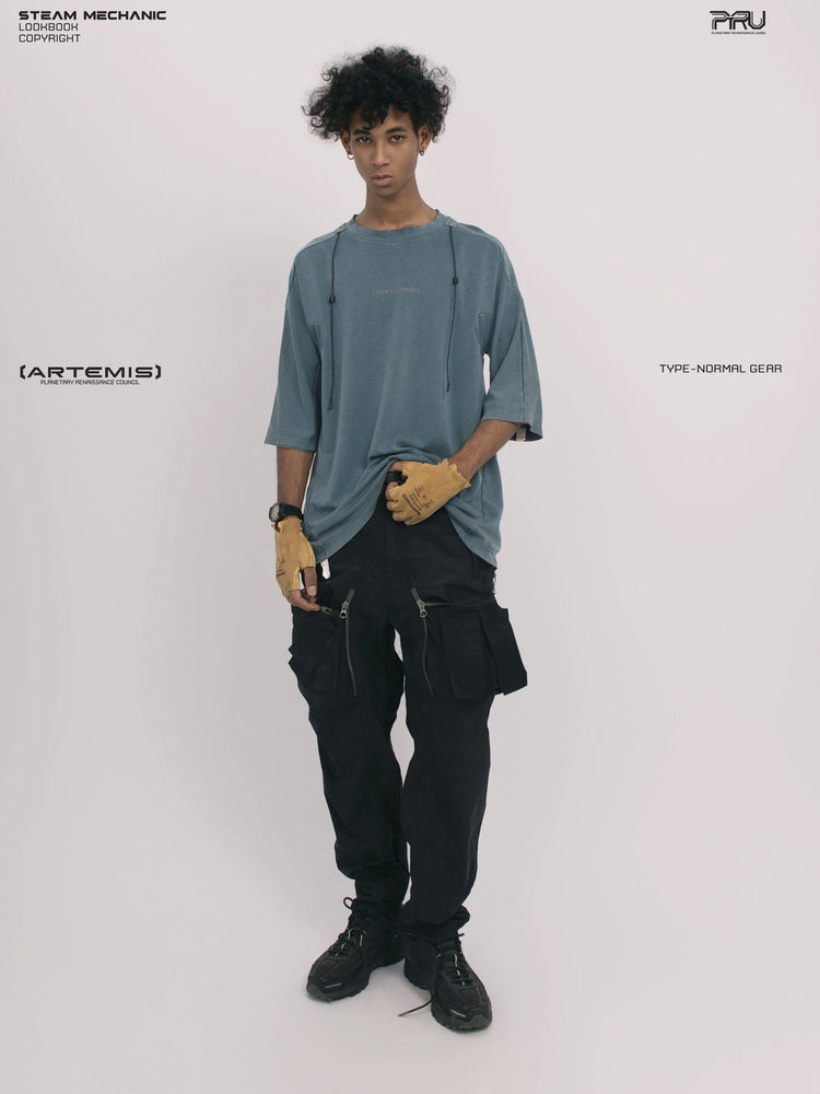 LIGHTSHADOW mycelium blue deconstructed technical tee — full-length front view holding the hem