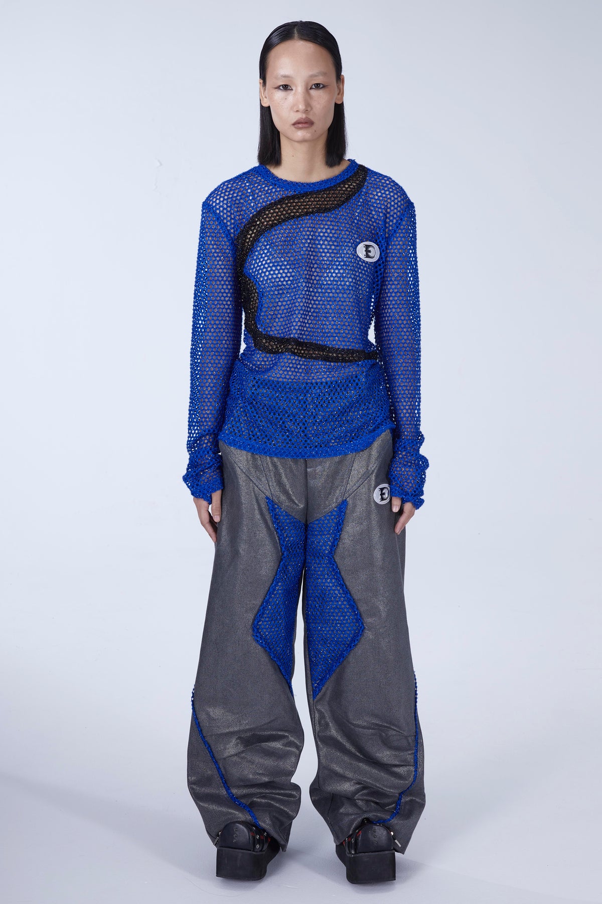 EMBRYO BLUE VOID cutout mesh finger-sleeve top — construction and silhouette detail