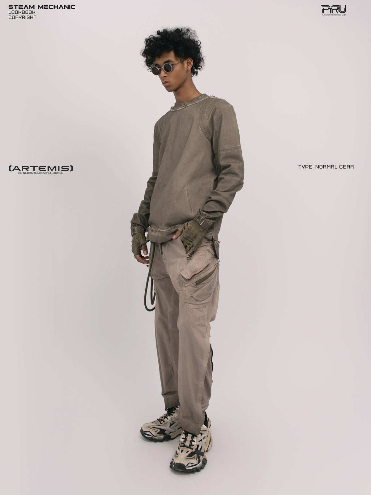 AEGIS xirang brown multi-pocket moto pants — opposite front three-quarter modeled view with one hand in the pocket