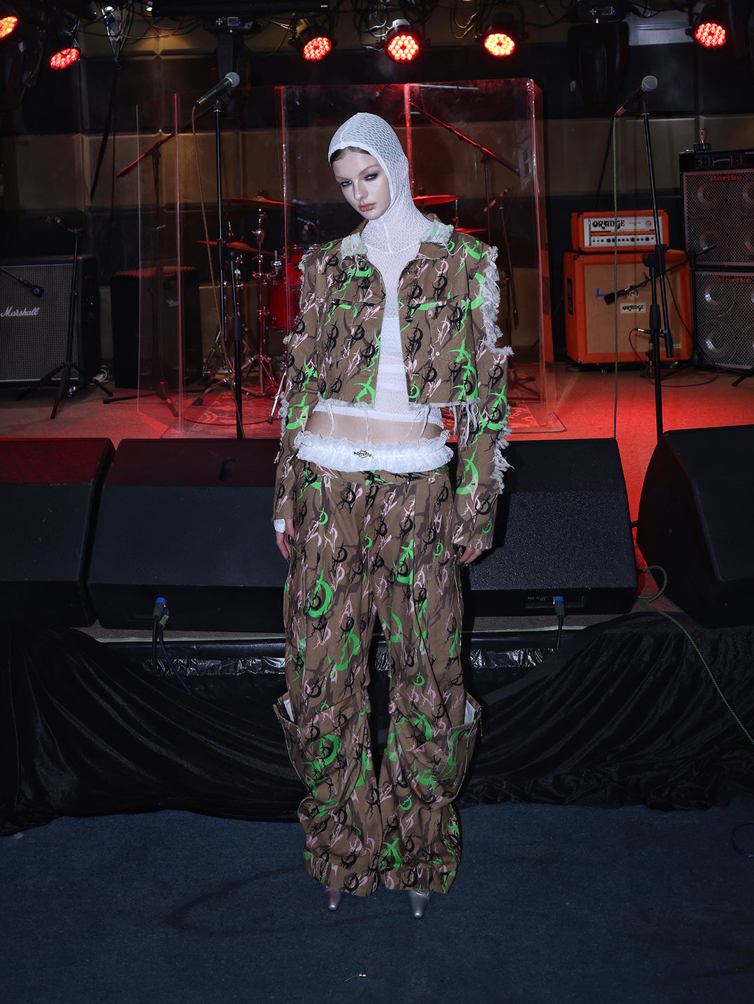 PINKSPINK ELECTRIC MOON distressed camo cropped jacket in CAMOUFLAGE — full-body front view with head tilted.