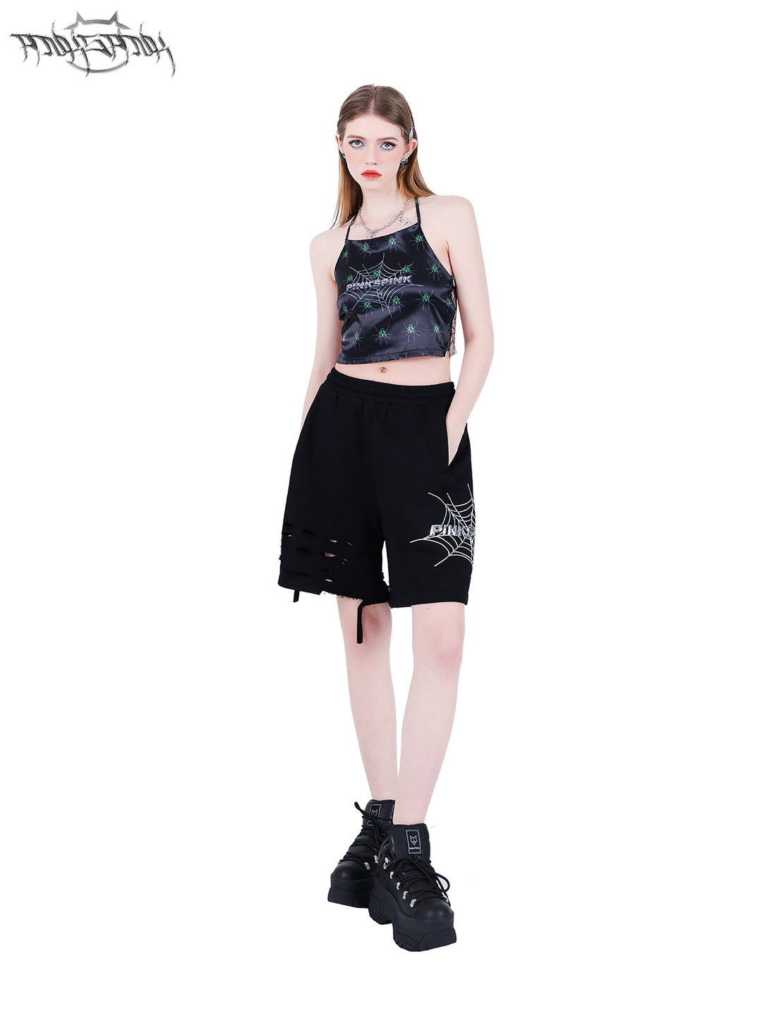 PINKSPINK SPIDER web-mesh halter crop top — front full-length modeled view with hands in shorts pockets