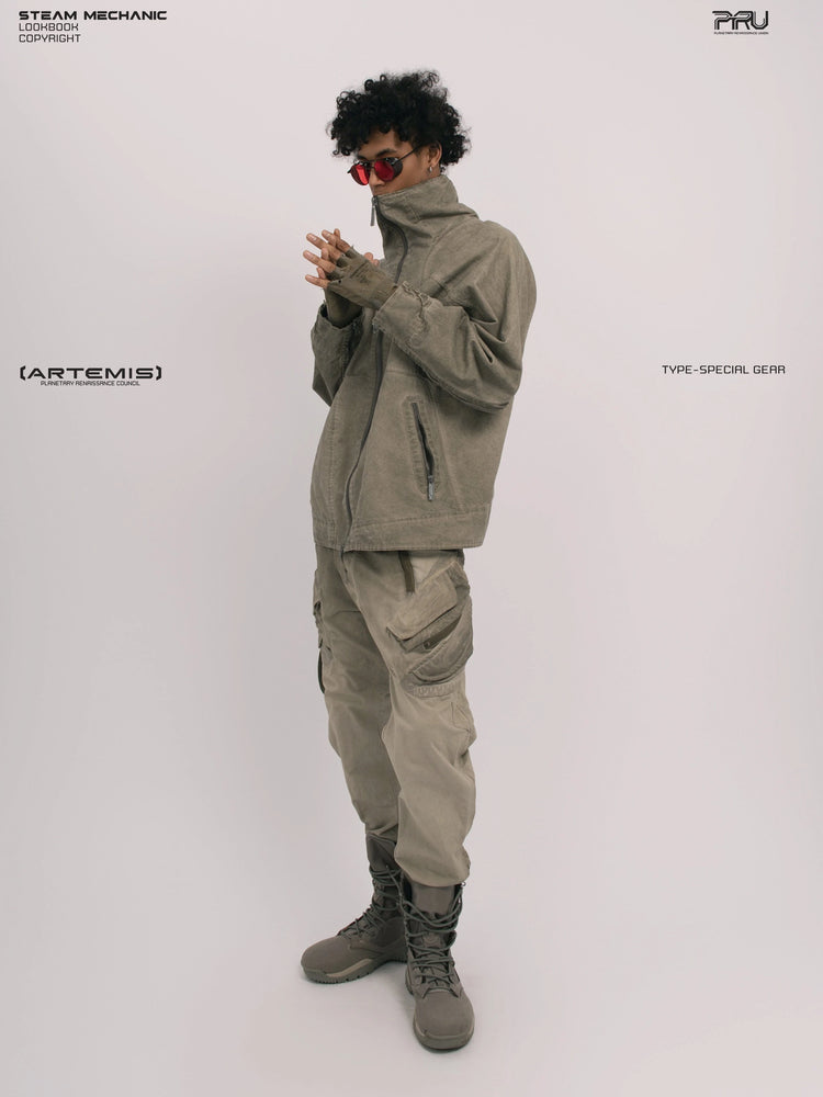 ARTEMIS xirang brown tuck-paneled technical jacket — full-length side three-quarter modeled view with hands clasped