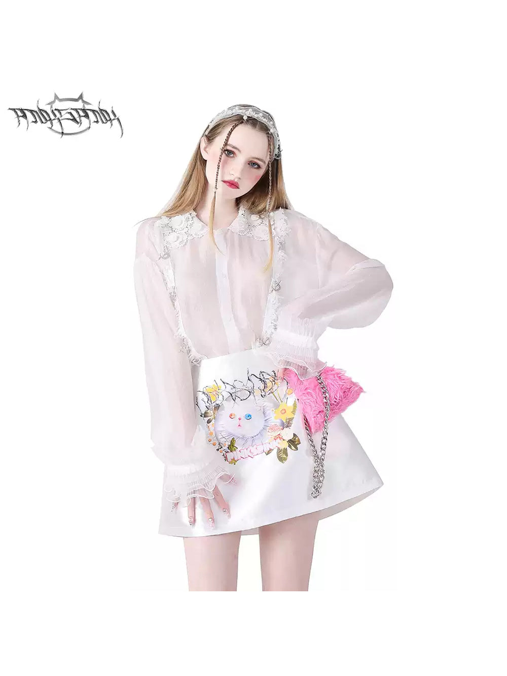 PINKSPINK GARFIELD graphic mini skirt — white front modeled close-up styled with a sheer lace blouse
