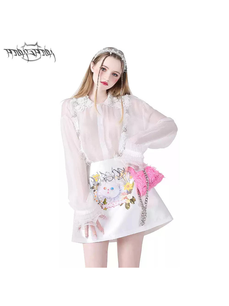 PINKSPINK GARFIELD graphic mini skirt — white front modeled close-up styled with a sheer lace blouse