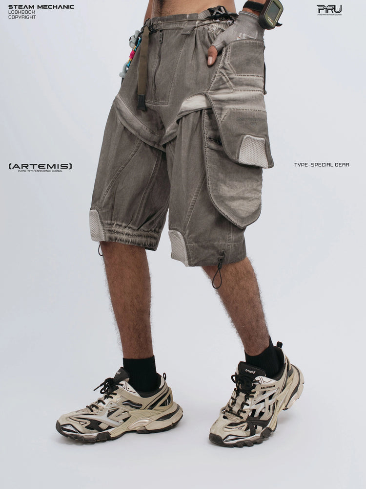 ARTEMIS xirang brown detachable technical shorts — side view with hand in pocket and crossed leg
