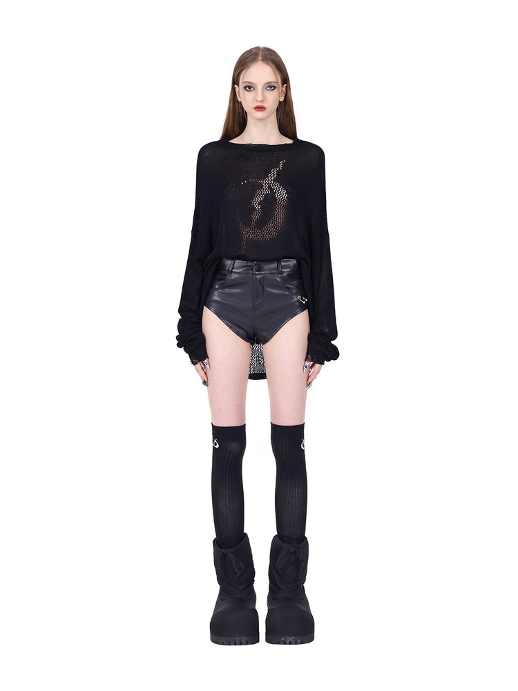 PINKSPINK ELECTRIC MOON distressed open-knit sweater in black — straight-on tucked front view with sleeves gathered above separate shorts