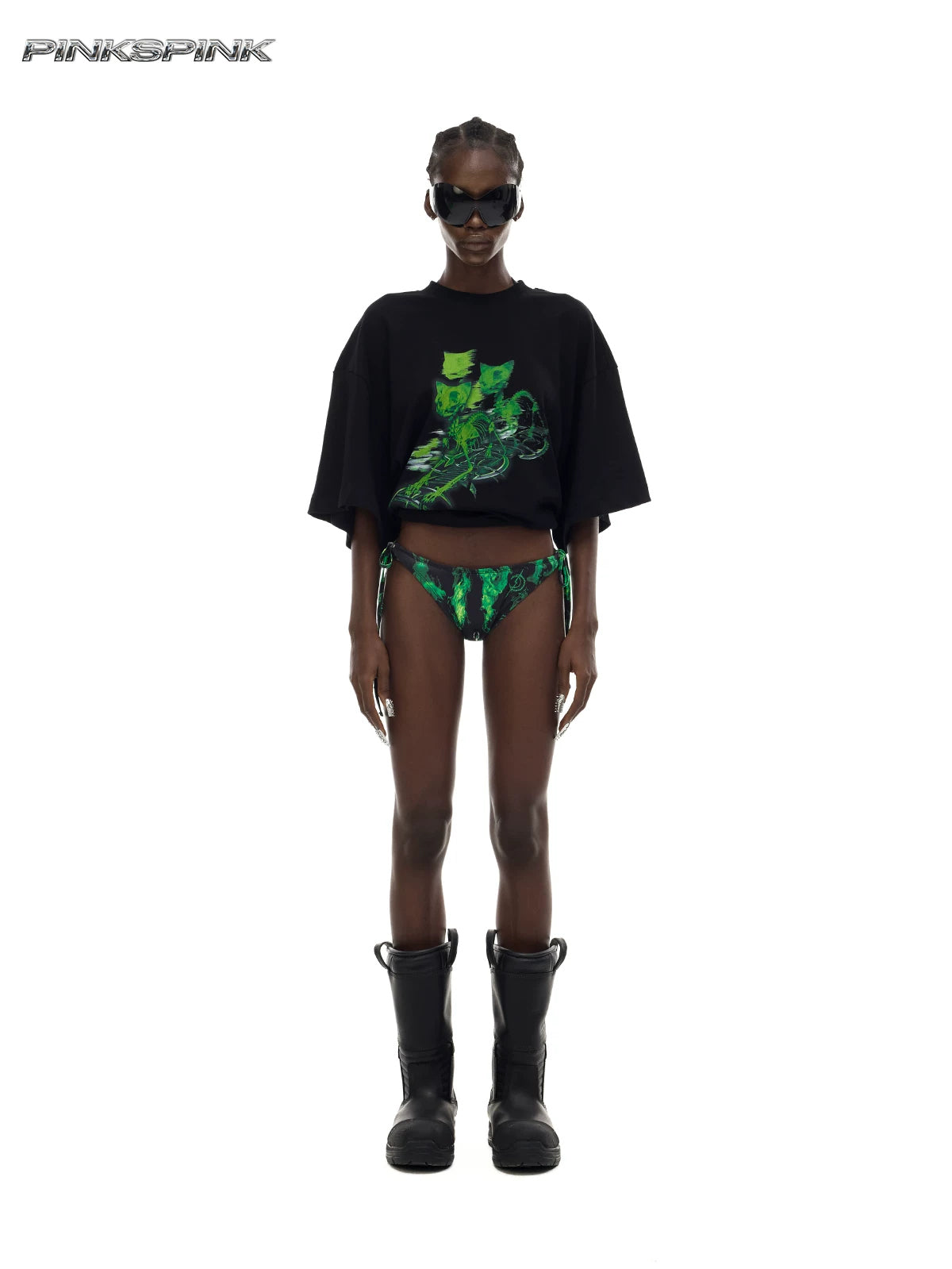 PINKSPINK MONSTER cat-skeleton oversized graphic tee in black — full-length front modeled view with the hem rolled up over separate printed bottoms
