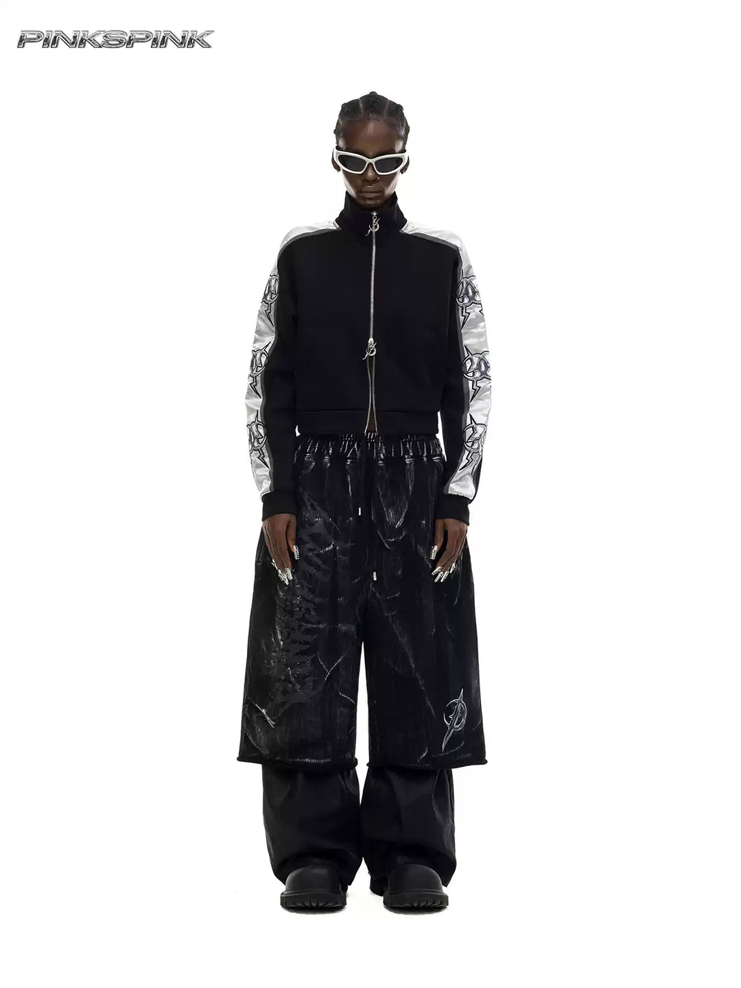 PINKSPINK ELECTRIC MOON coated cropped wide-leg pants in black — front full-length modeled view styled over separate black trousers