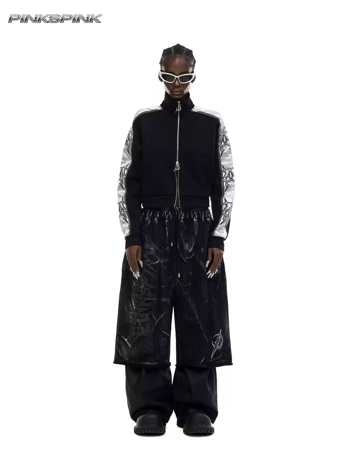 PINKSPINK ELECTRIC MOON coated cropped wide-leg pants in black — front full-length modeled view styled over separate black trousers