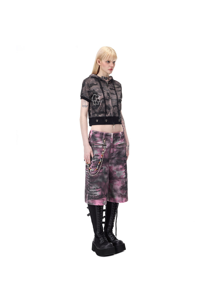 PINKSPINK ELECTRIC MOON coated camouflage denim shorts in pink-gray camouflage — full three-quarter view with chain styling