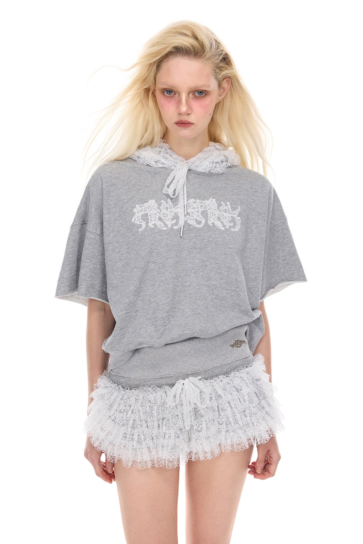 PINKSPINK MULTIVERSE lace micro shorts skirt — modeled detail view of the garment construction