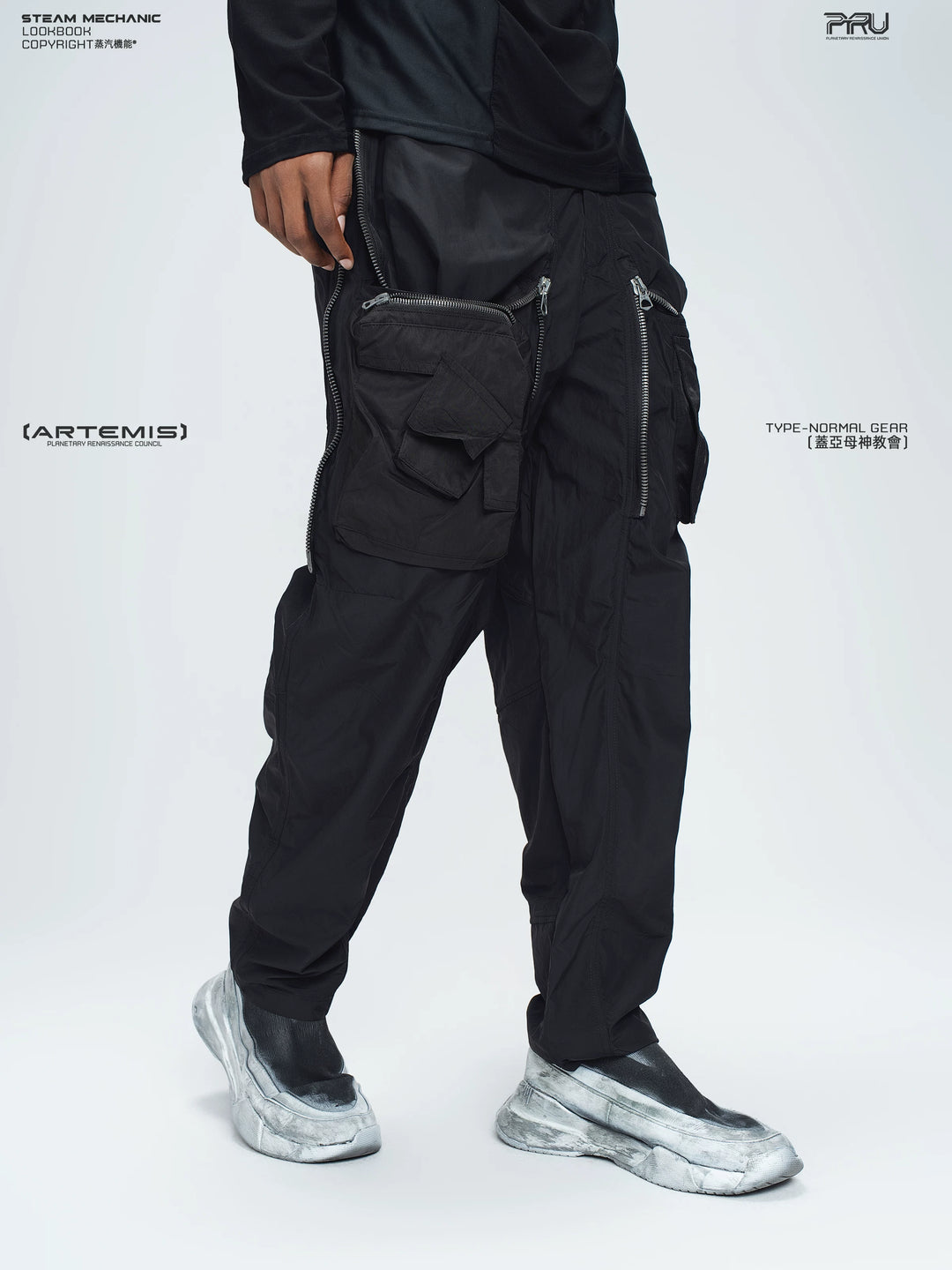 GAIA stone green curved-blade technical pants — full-length styled view