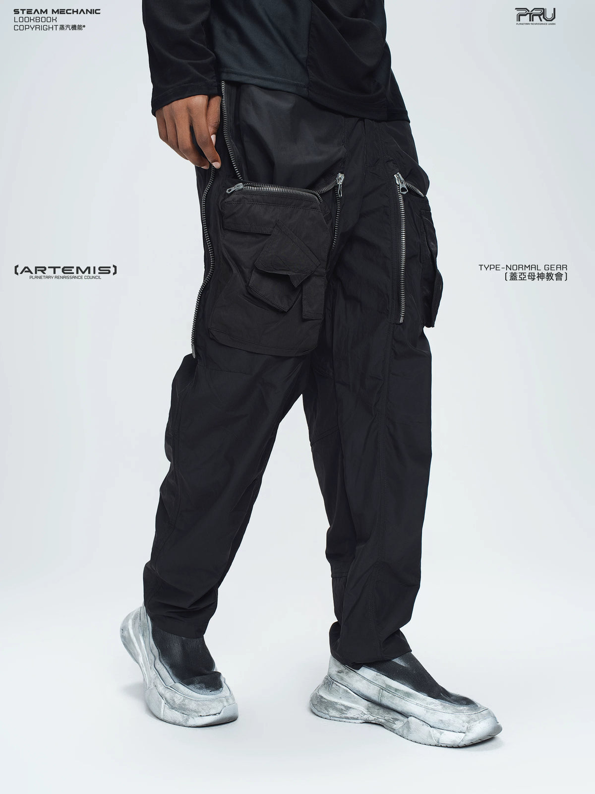 GAIA stone green curved-blade technical pants — full-length styled view
