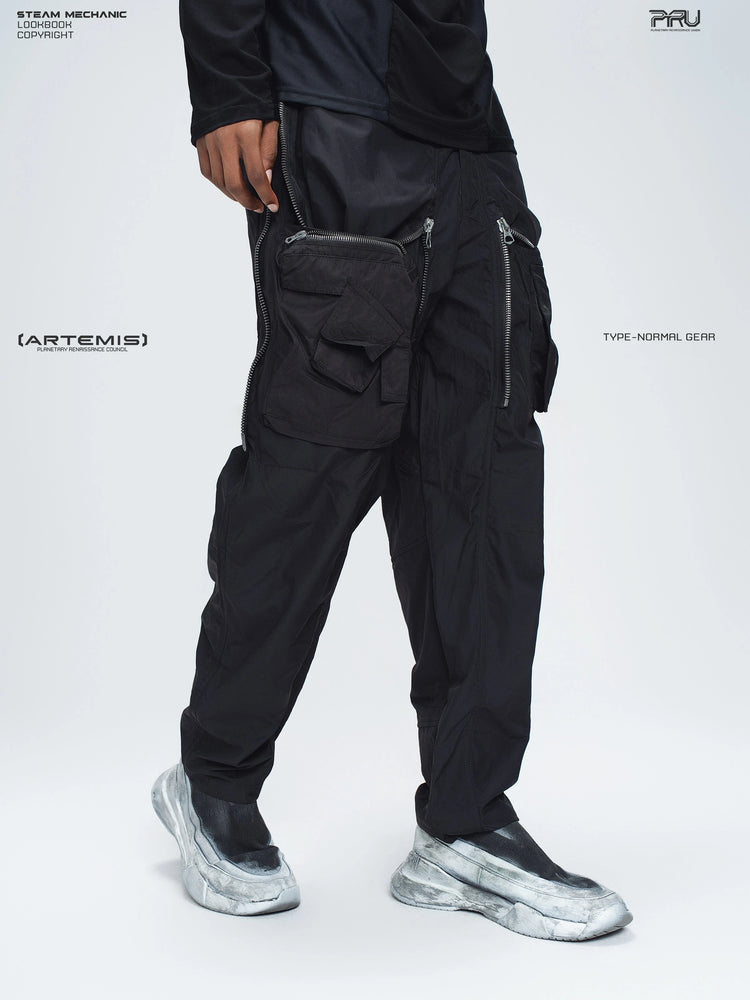 GAIA black curved-blade technical pants — three-quarter modeled view showing the open overlays and pockets