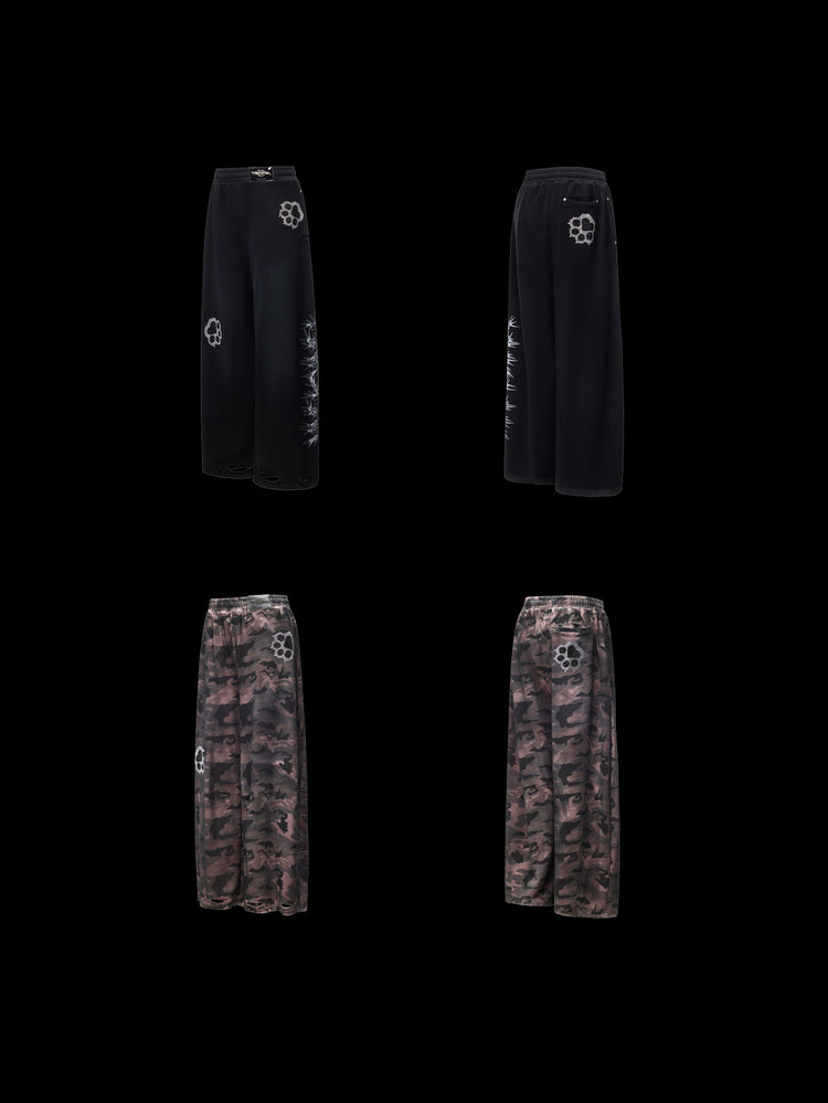 PINKSPINK CATPAW rhinestone curved-leg sweatpants in black and gray-brown camouflage — garment-only front and back comparison on a clean black background