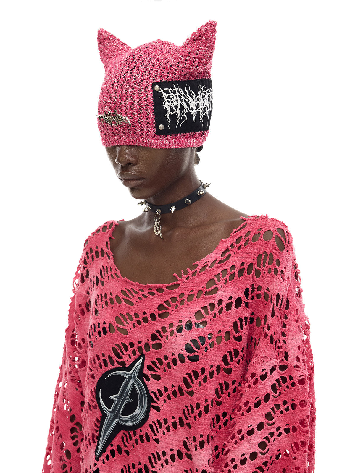 PINKSPINK ELECTRIC MOON distressed open-knit oversized tee in pink — close angled modeled view showing the moon appliqué