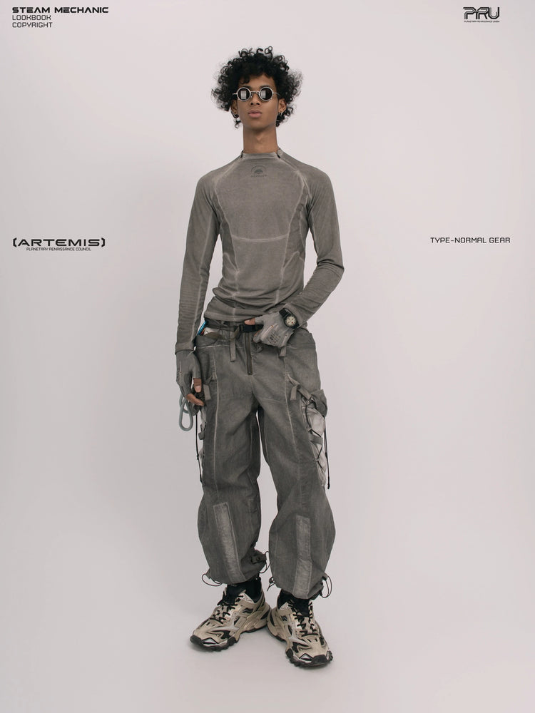 TWIN STAR meteor gray stretch riding base-layer top — full-length front view with the opposite hand at the waist