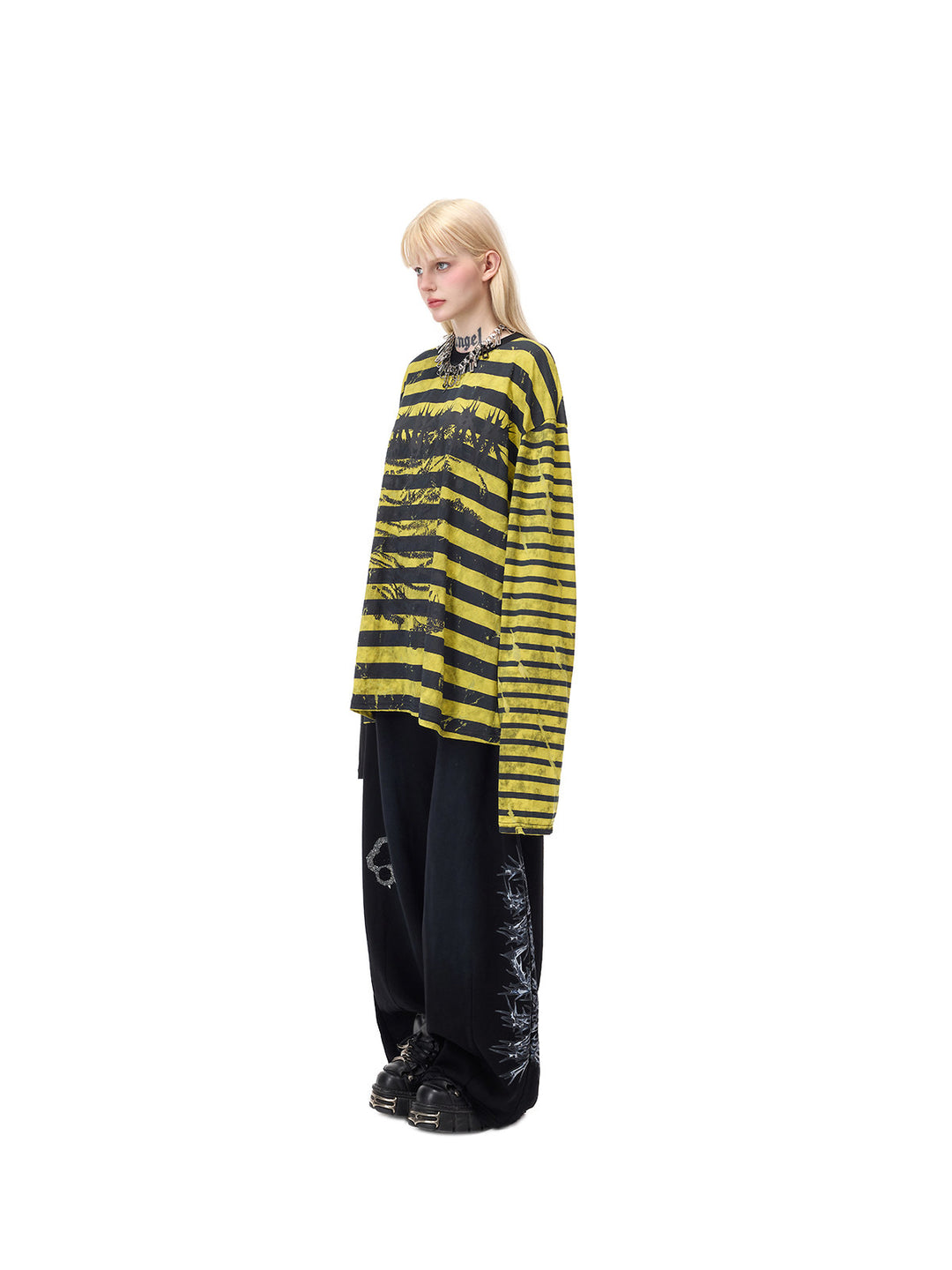 PINKSPINK STATIC asymmetric striped burnout long-sleeve tee in black and yellow — full-length side modeled view showing the long striped sleeve