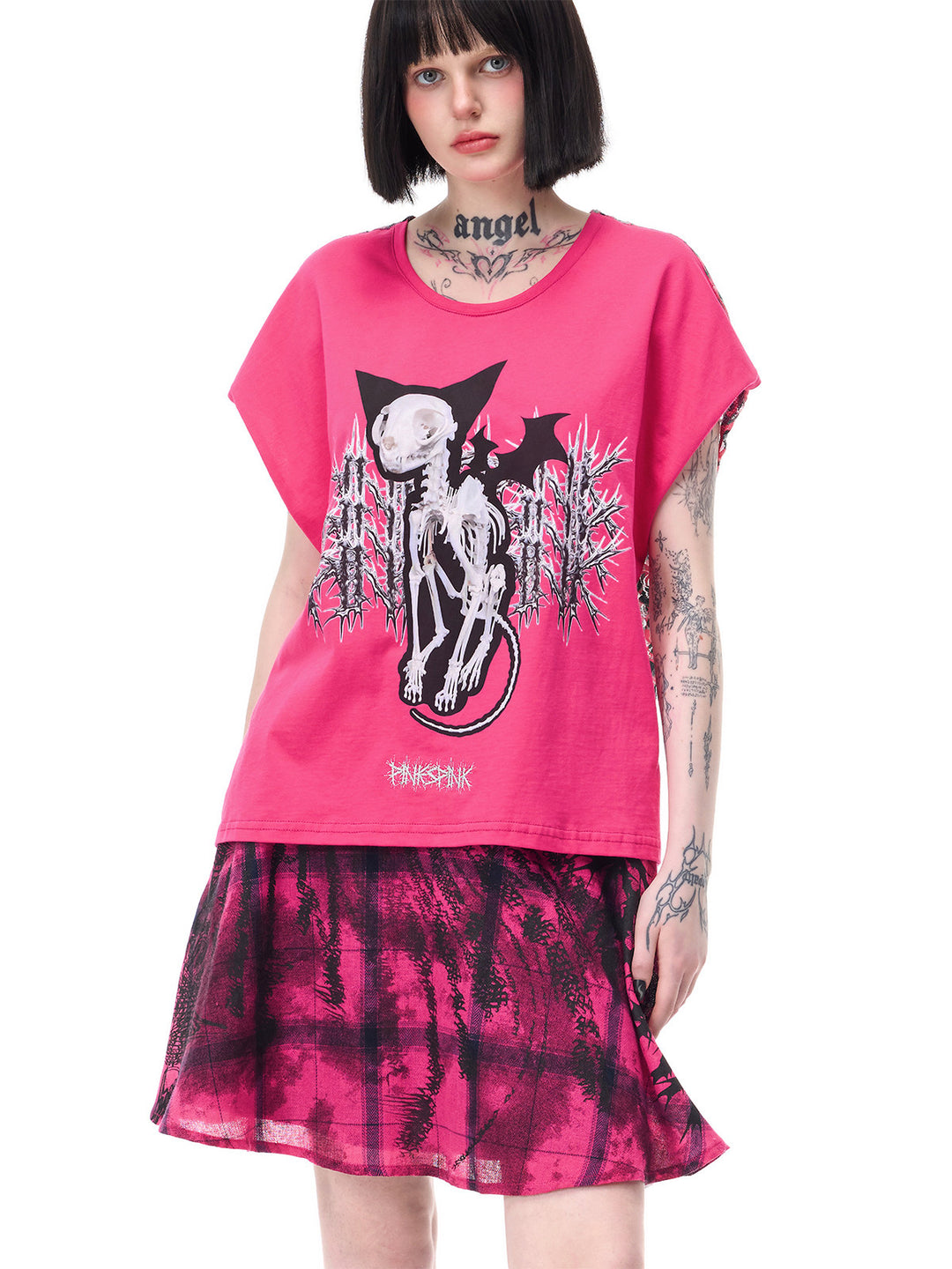 PINKSPINK FUTURE PORTRAIT reversible graphic mini skirt in black and pink — close modeled view of the plaid panel beneath a separate pink graphic tee
