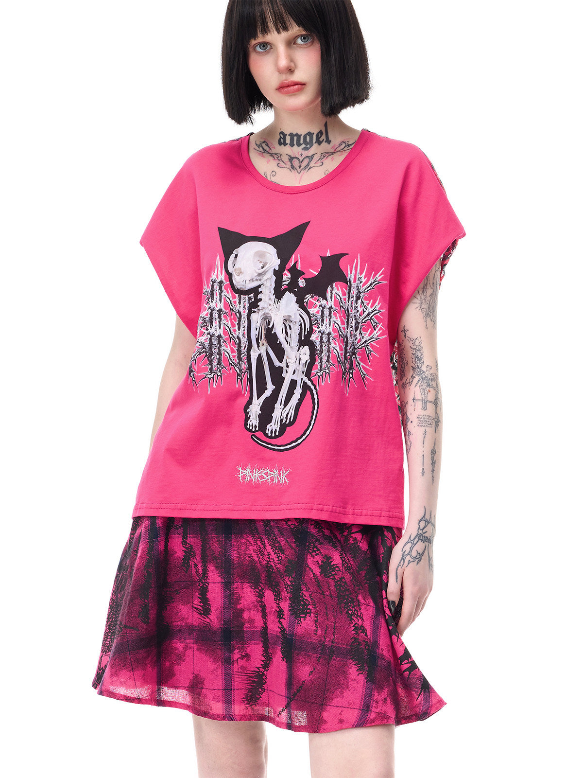PINKSPINK FUTURE PORTRAIT reversible graphic mini skirt in black and pink — close modeled view of the plaid panel beneath a separate pink graphic tee