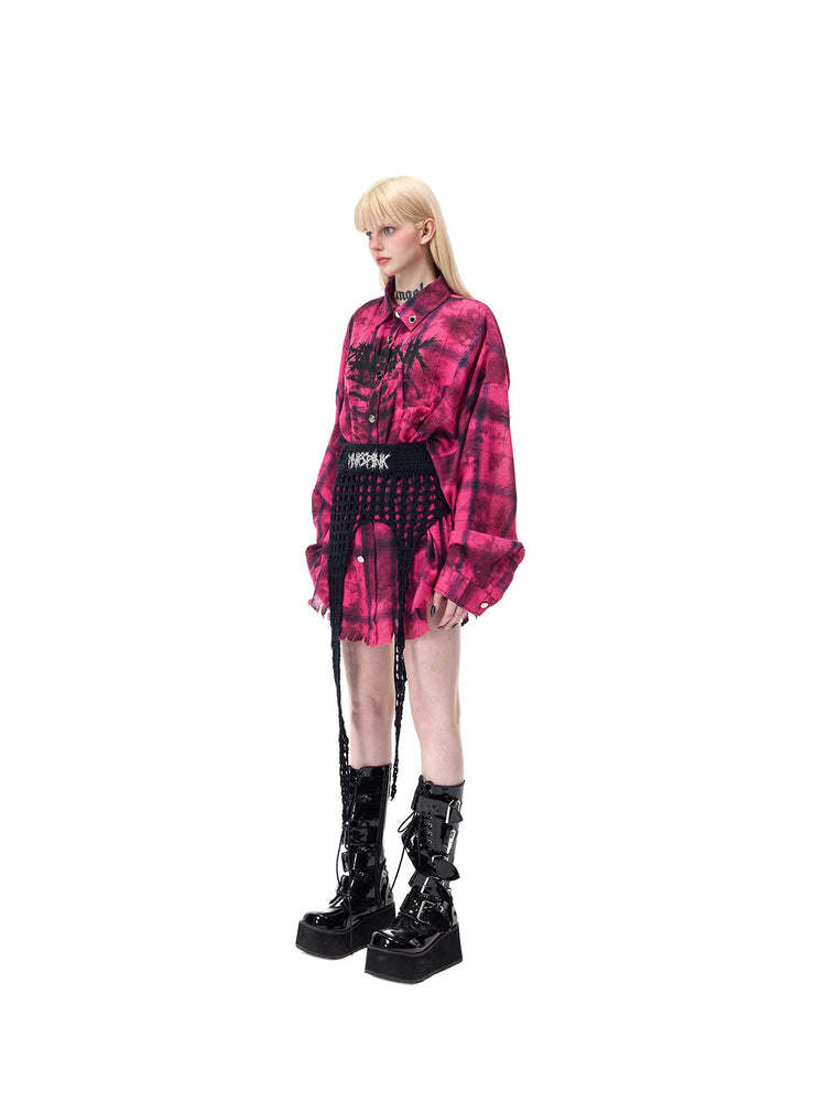 PINKSPINK THORNSTAR open-knit layering skirt in black — angled full-length side modeled view over a separate pink plaid shirt