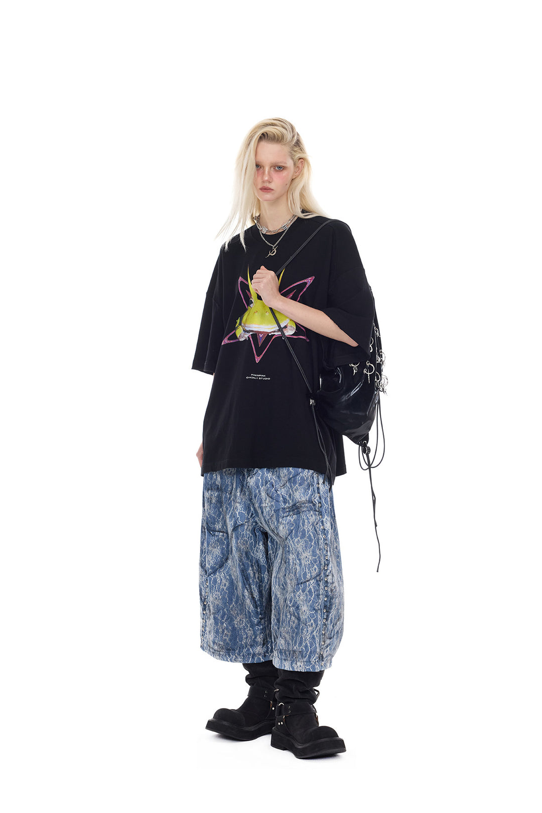 PINKSPINK ELECTRIC MOON lace-coated wide-leg denim shorts in blue — full-length angled modeled view with a graphic tee and black bag