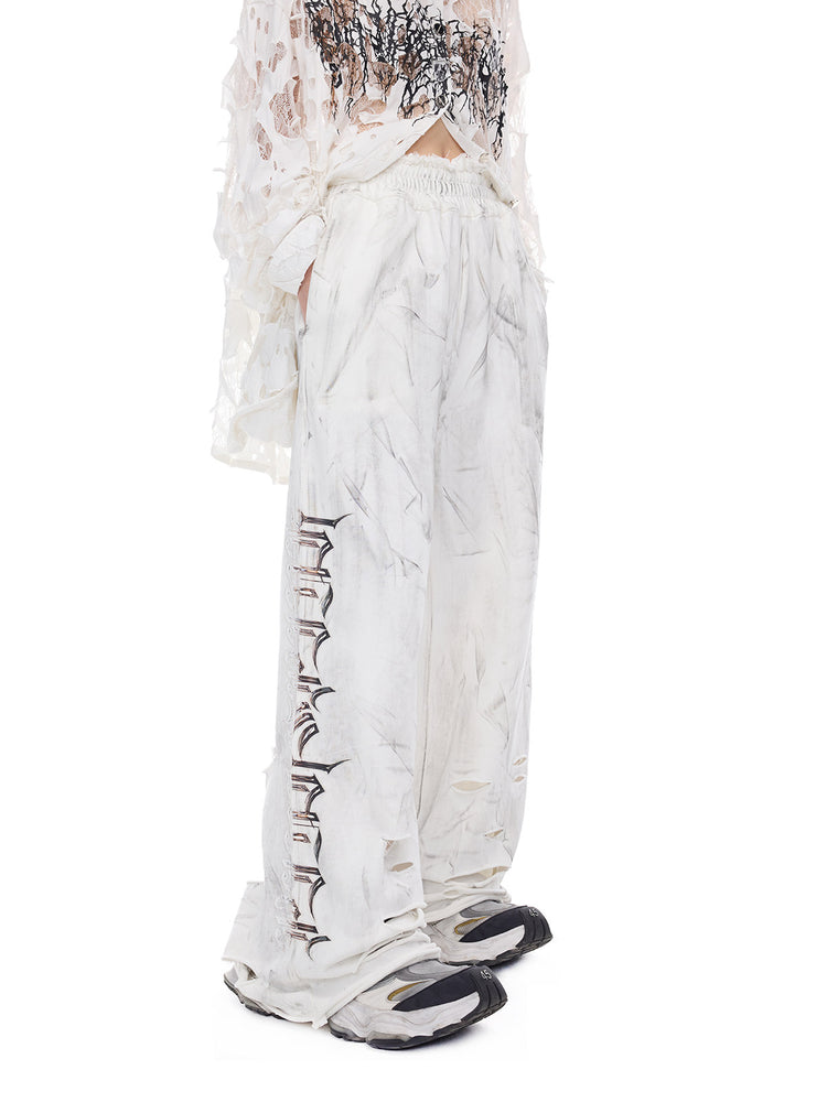 PINKSPINK ELECTRIC MOON coated distressed flare sweatpants — close-up view of the material and finishing