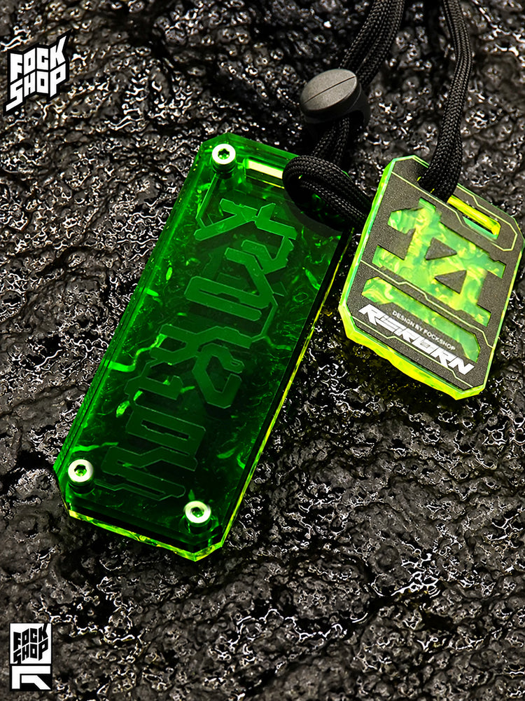 FOCKSHOP REBORN talisman charm — GREEN RIPPLE front view with fluorescent backing and a smaller hanging plaque