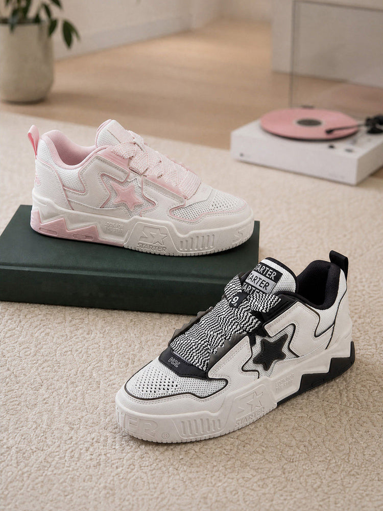 Pink and black-and-white STARTER VOL 90S mesh sneakers displayed beside a record player