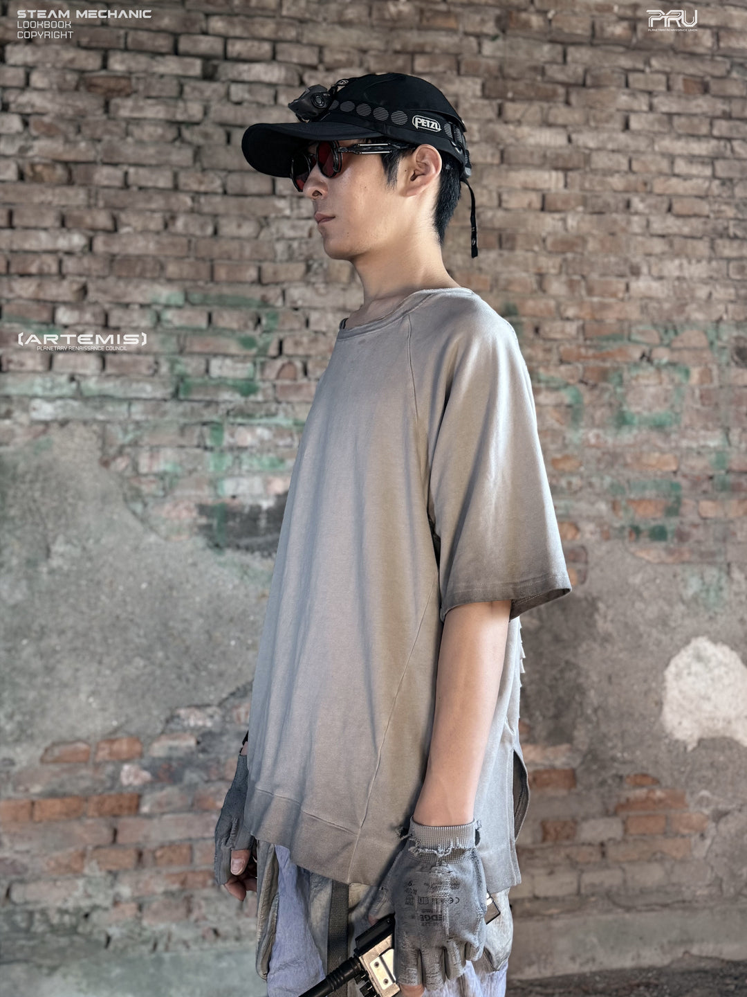 ERODED SPINE distressed asymmetric tee in oxidized white — side modeled view showing the loose sleeve and asymmetric hem