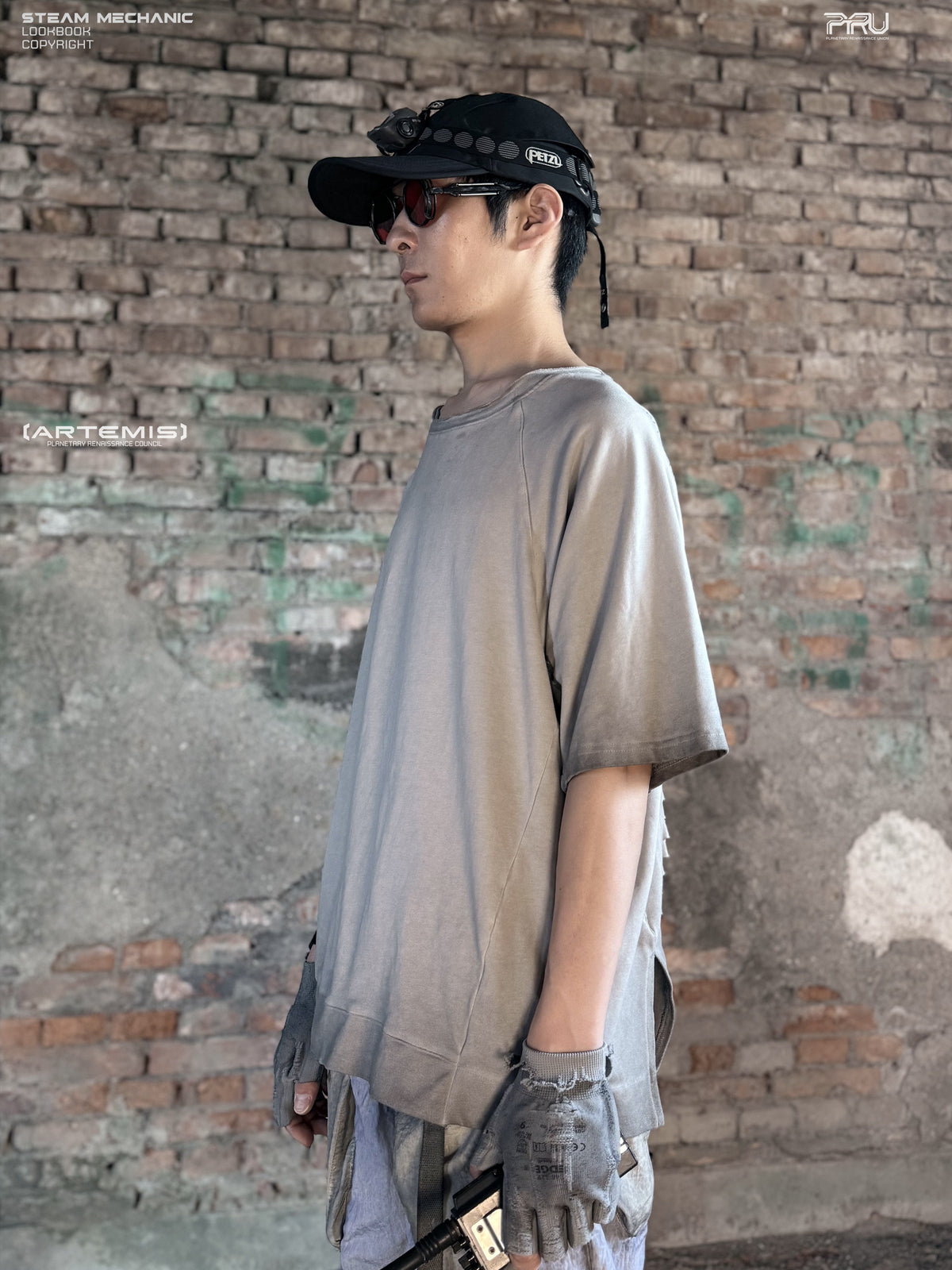 ERODED SPINE distressed asymmetric tee in oxidized white — side modeled view showing the loose sleeve and asymmetric hem
