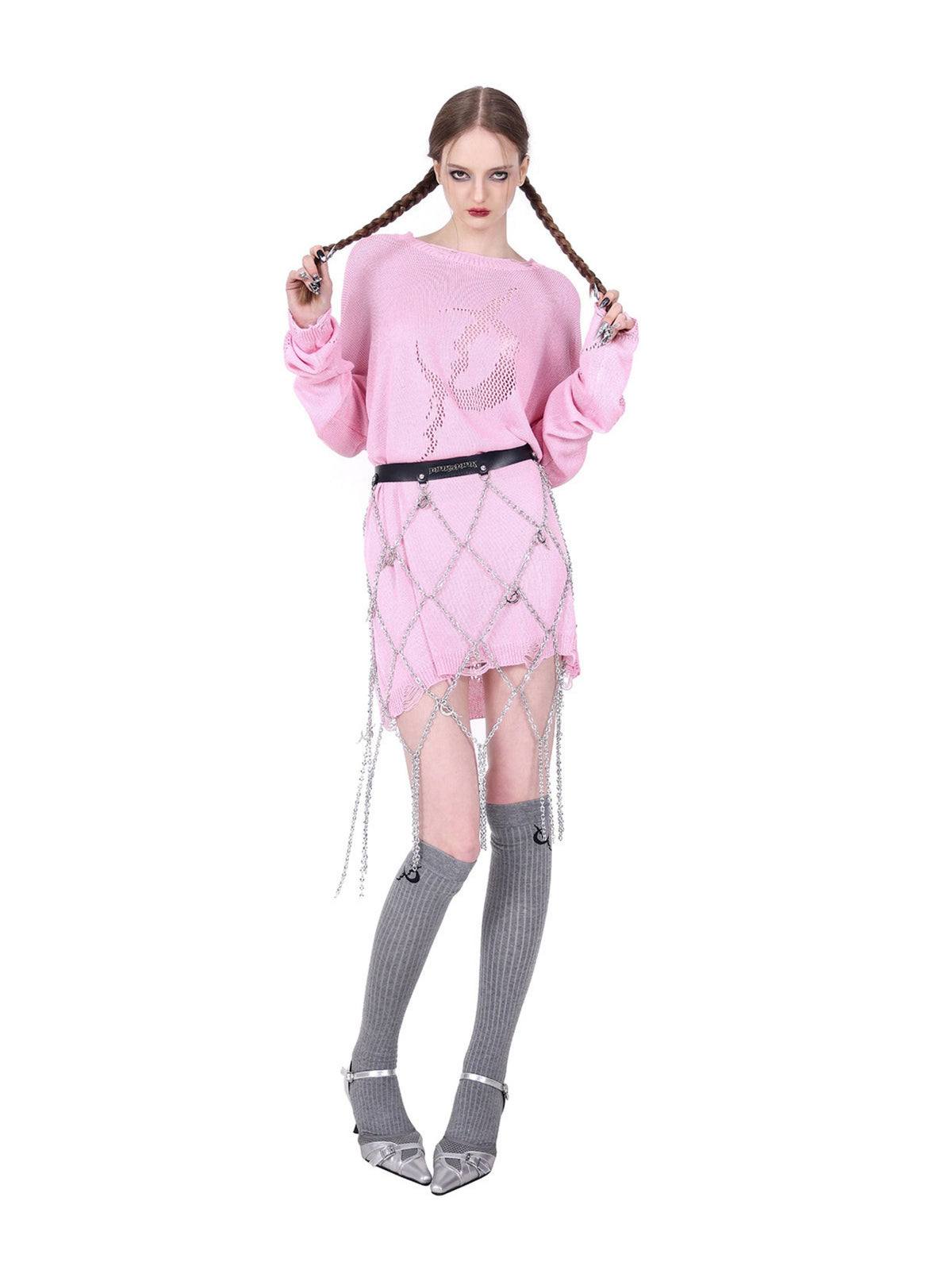 PINKSPINK ELECTRIC MOON diamond-chain belt skirt in black and silver — full-length front pose over a pink knit with the model holding her braids