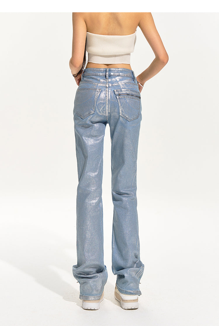 NAWS wax-coated zip-hem jeans in GLACIER LAKE BLUE — modeled rear view showing the pockets and long straight legs.