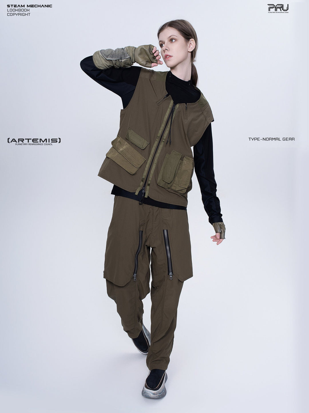 GAIA curved-blade technical pants in mountain green — full-length styling view with a model leaning to one side