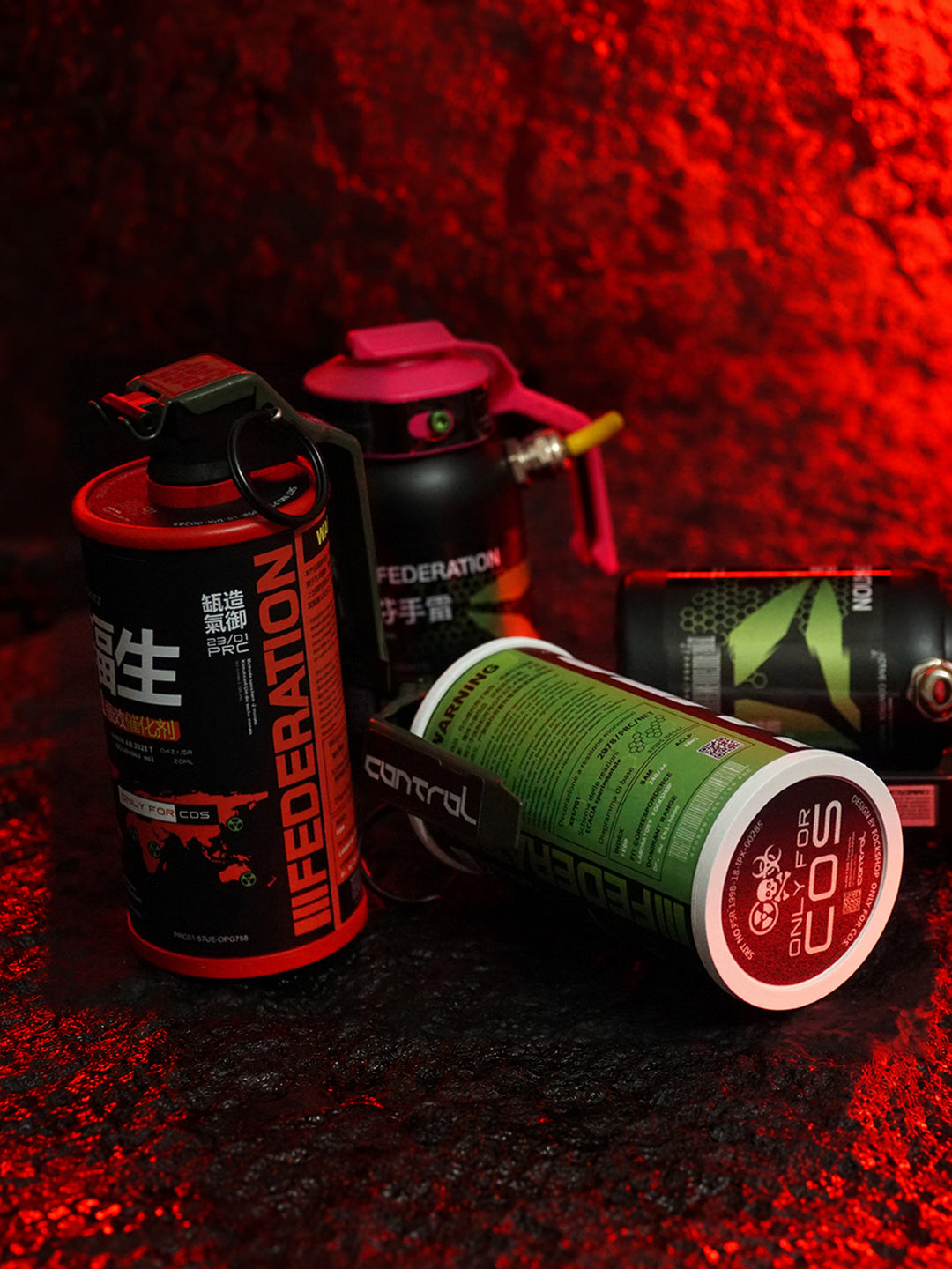 FOCKSHOP REBORN reactor canister prop — red-lit studio arrangement of red and green canisters on textured fabric