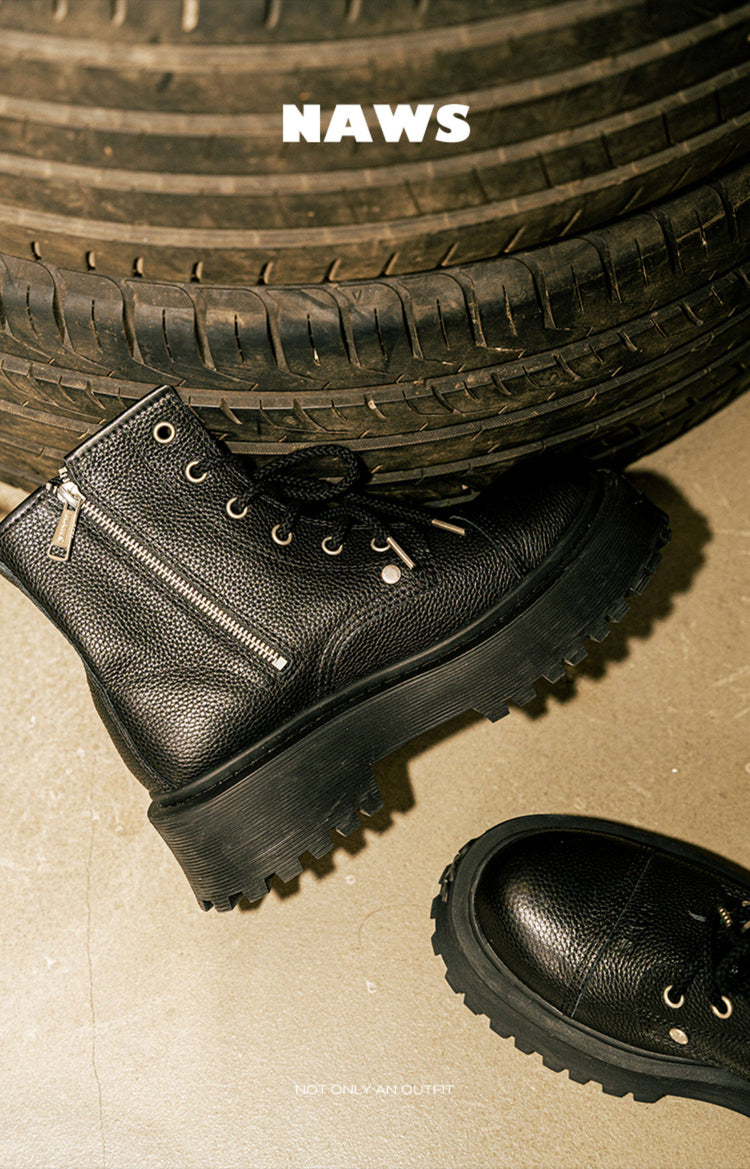 NAWS KNIGHT leather platform lace-up boots in MOORE BLACK — shoe-only styled view beside a vehicle tire.