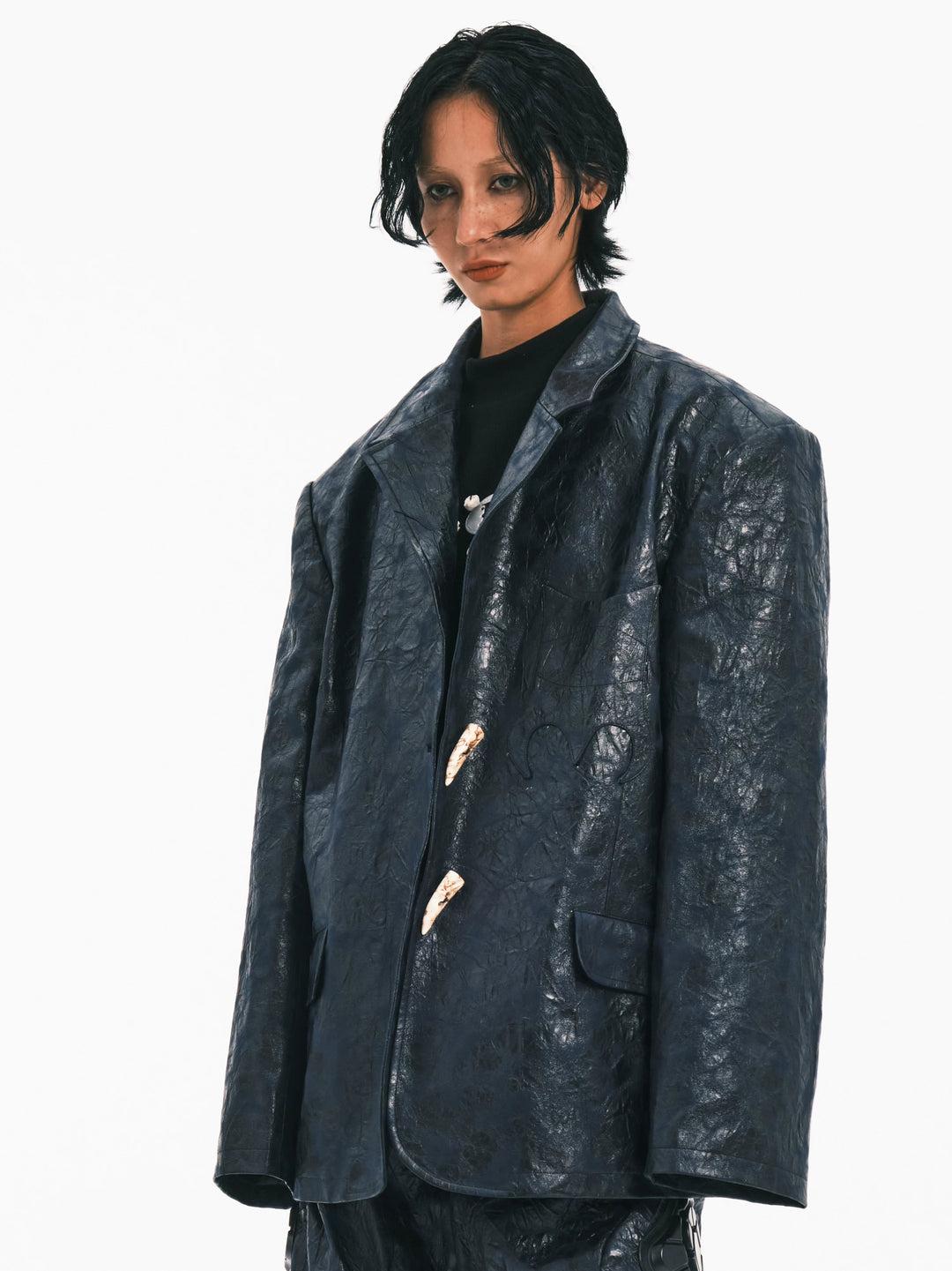 EMBRYO HORN CODE textured PU leather blazer — three-quarter modeled view
