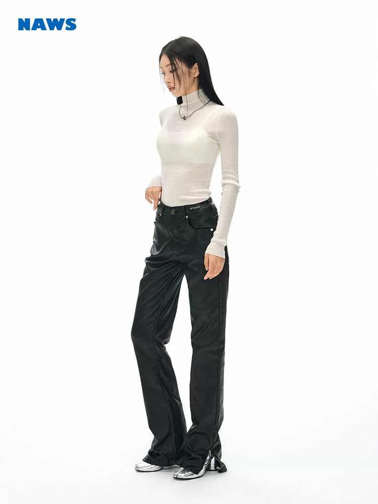 NAWS wax-coated zip-hem jeans in BATIK BLACK — three-quarter full modeled view showing the wax-coated straight legs and zip hems.