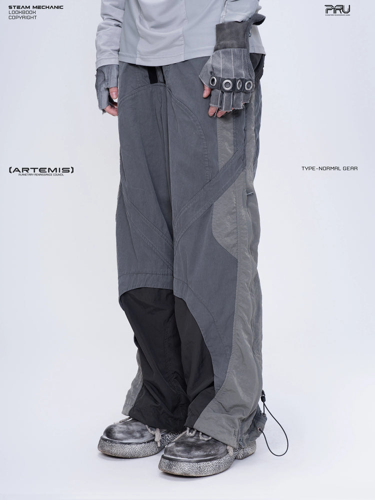 SUPERNOVA alloy gray metallic nylon technical pants — three-quarter front modeled close-up facing left
