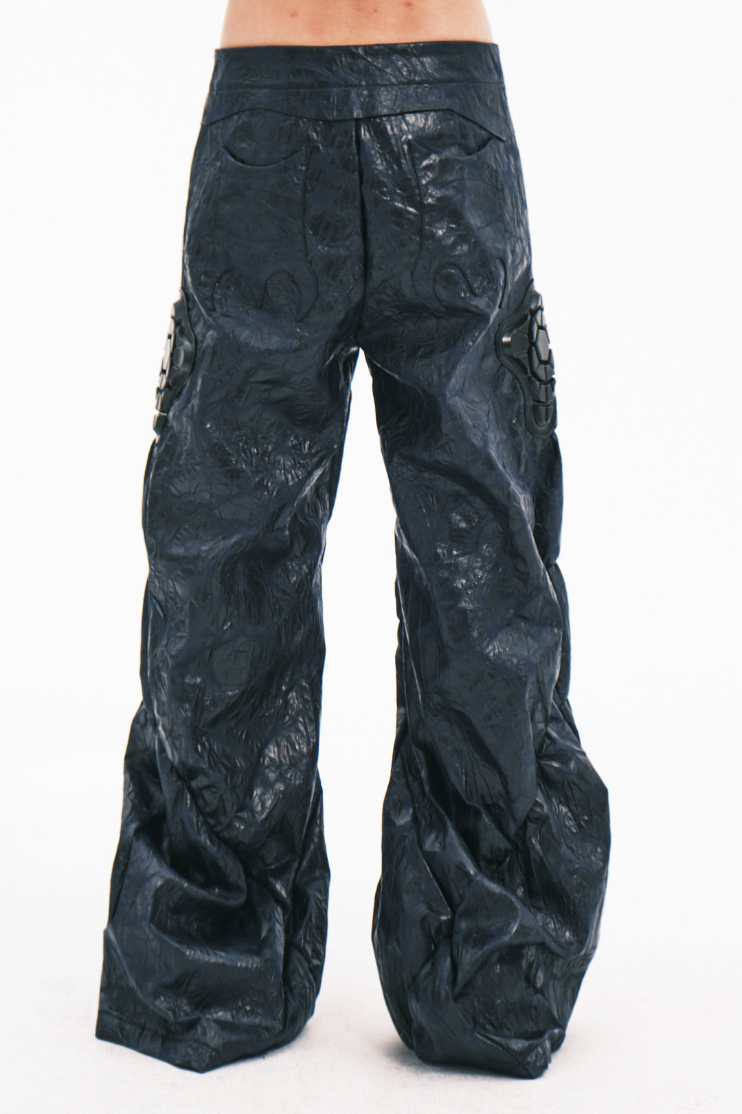 EMBRYO GUARD SHELL ruched PU leather flare pants — garment-only construction view