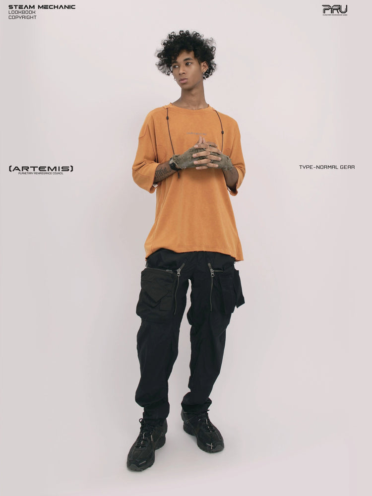LIGHTSHADOW eclipse orange deconstructed technical tee — full-length front view with clasped hands and an alternate head angle