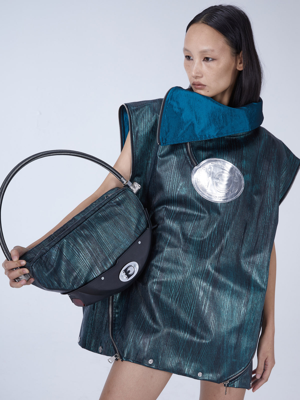 EMBRYO TIRELINE embossed underarm bag — close modeled view