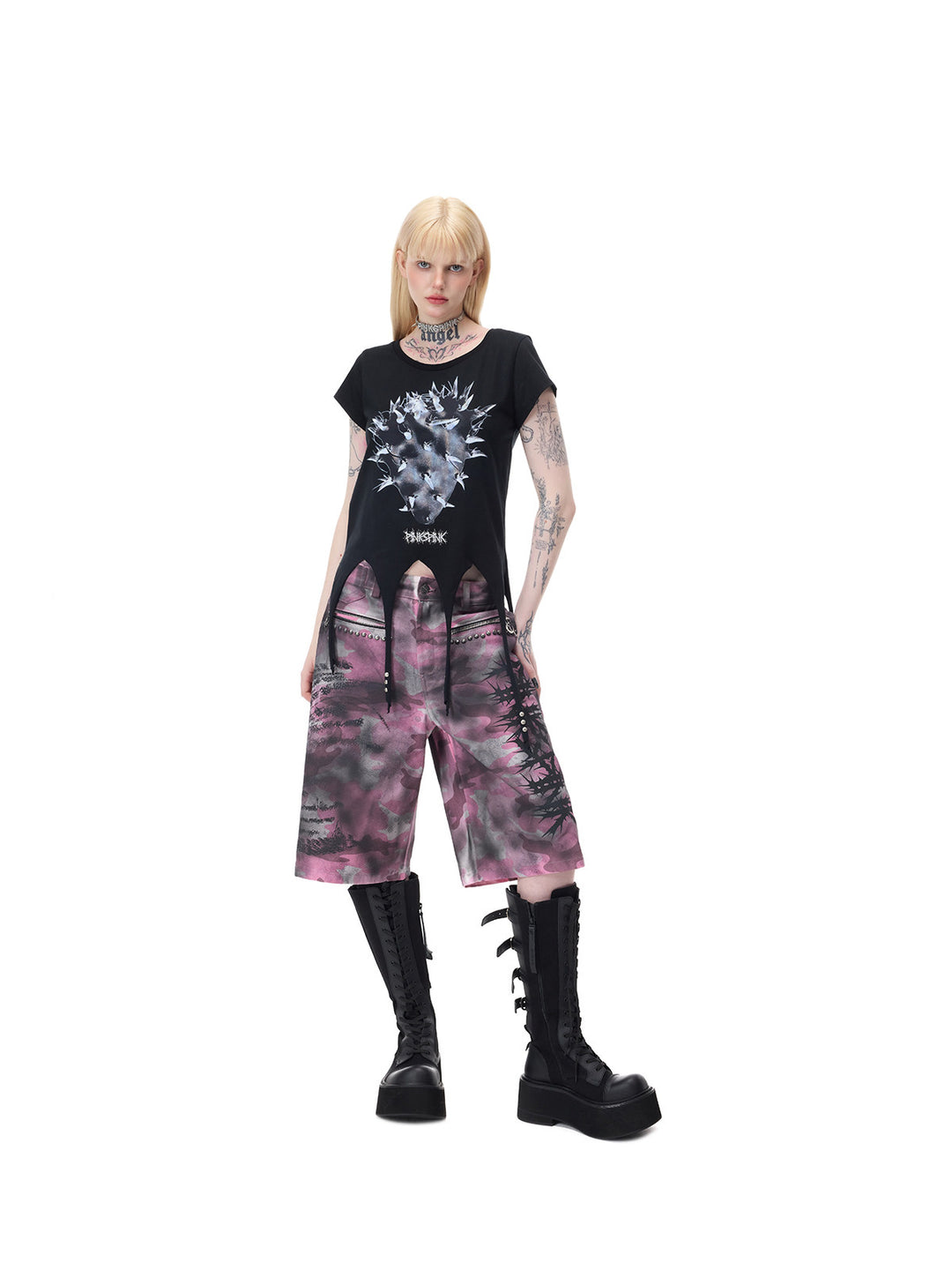 PINKSPINK PUNK CACTUS studded pointed-hem tee in black — full-length three-quarter front modeled view with one hand in the shorts pocket