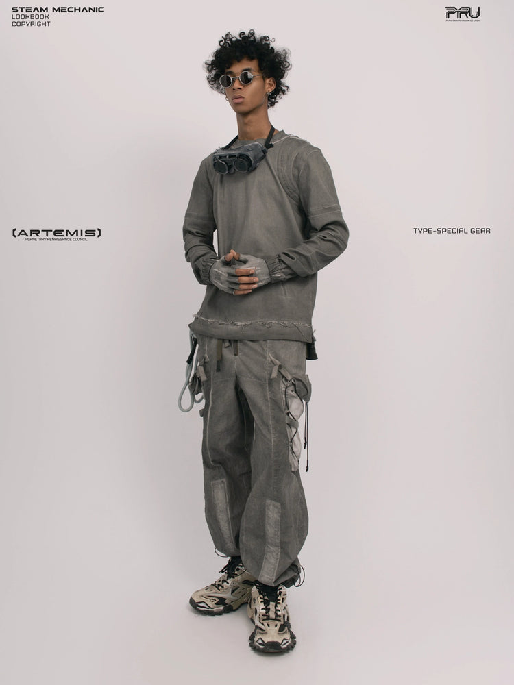 CHAOS ERA moon dust gray raw-edge long-sleeve top — full-length three-quarter front view with hands clasped