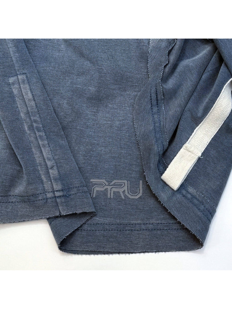 LIGHTSHADOW mycelium blue deconstructed technical tee — blue hem stitching, interior tape and PRU logo close-up